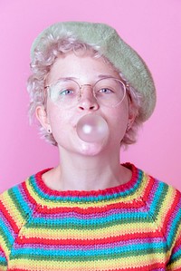 Caucasian woman blowing bubble gum