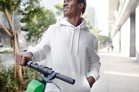 Streetwear white hoodie mockup psd man riding scooter stylish apparel