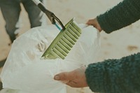 Beach cleanup volunteers picking up trash for environment campaign