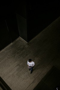 Businessman holding tablet, walking into building