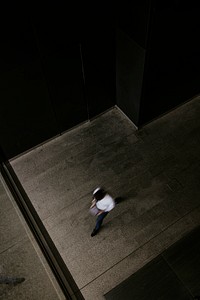 Businessman holding tablet, walking into building