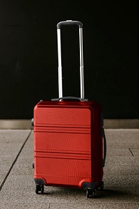 Red travel luggage on floor photo