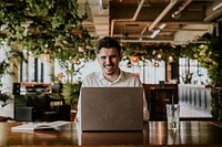 Businessman working on laptop, co-working space photo