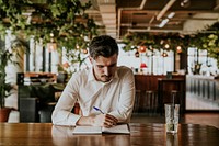 Businessman writing on notebook, co-working space photo