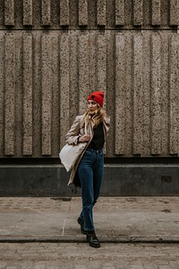 Blonde woman walking in city alone