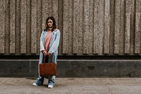 Woman holding brown leather bag