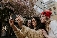 Diverse girl friends taking selfies