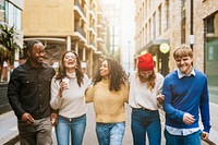 Happy diverse friends walking in city