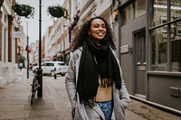 Cheerful woman walking in city