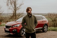 Man on road trip, standing with hands in pockets photo