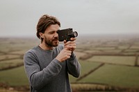 Man recording video with film camera