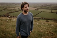 Man wearing long sleeve shirt, walking on hill