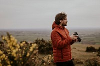 Photographer holding camera, nature photography