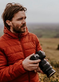 Photographer holding camera, nature photography