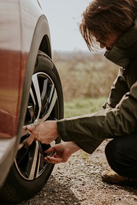 Man checking car tire photo