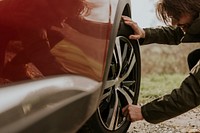 Man checking car tire photo