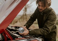 Man filling screen wash, car maintenance photo