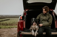Dog & man on road trip, sitting at the back of a car photo