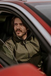 Confident man sitting in car photo