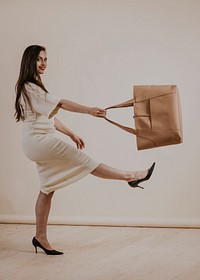 Businesswoman in beige dress, leather handbag