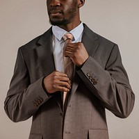 African man adjusting tie, business attire studio shoot