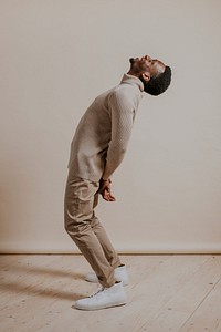 Man wearing beige sweater, khaki pants, minimal fashion