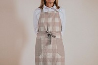 Woman wearing brown apron, studio shoot
