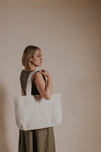 Woman carrying white tote bag, minimal fashion