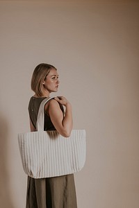 Woman carrying white tote bag, minimal fashion