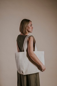 Woman carrying white tote bag, minimal fashion