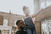 Happy dad carrying daughter on shoulders