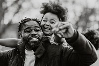 Happy dad carrying daughter on his back