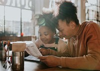 Mum and daughter looking at menu