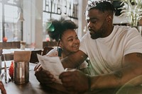 Dad and daughter looking at menu