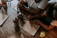 Daughter drawing with dad at a restaurant