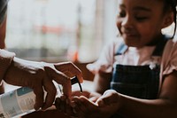 Little girl getting hand sanitizer