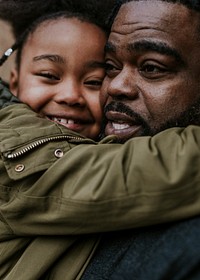 Daughter hugging her dad, African-American family photo