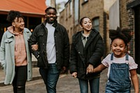 African-American family holding hands, walking in the city