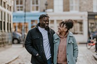 African-American couple hugging, walking in city