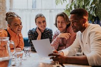 Diverse friends checking out menu at a restaurant