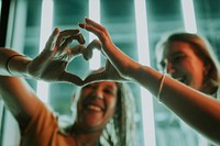 Friends showing heart hands, friendship photo