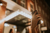 Hand holding smartphone, checking GPS