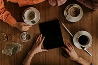 Tablet on table, business planning at a cafe