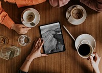 Tablet on coffee table, digital device flat lay