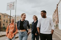 Cheerful diverse friends walking in the city