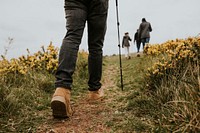 Hiking boots closeup, man trekking on hill