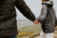 Two sisters holding hands while hiking