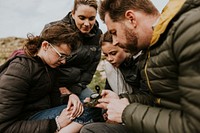 Traveling family looking at compass photo