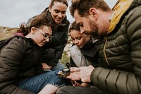 Traveling family looking at compass photo