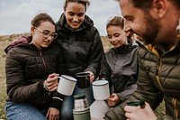 Camping family having morning drinks